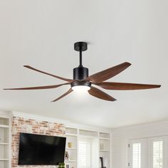 a ceiling fan in a living room next to a tv