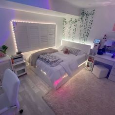 a bedroom with white furniture and plants on the wall