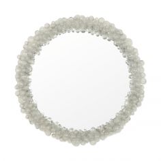 a white beaded bracelet with a round mirror in the middle on a white background