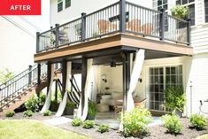 an outdoor deck with stairs leading up to the upper floor and second story above it