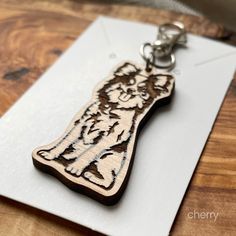 a wooden keychain with a tiger design on it