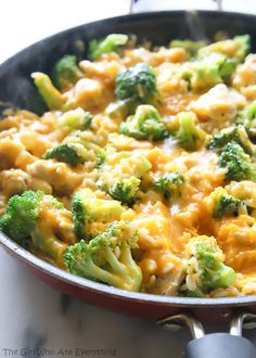 broccoli and chicken casserole in a skillet with cheese on top