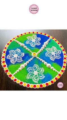 a cake decorated with multicolored designs on a wooden table