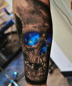 a man's leg with a skull and blue eyes