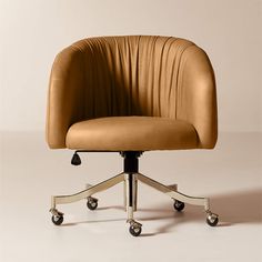 an office chair with wheels and a tan upholstered seat on a white background