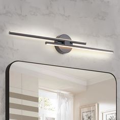 a bathroom mirror that has a light on it