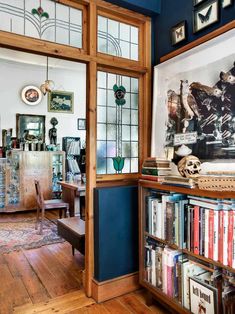 a living room filled with furniture and lots of books