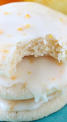 a close up of a doughnut with icing on a plate next to an apple