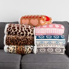 a couch with several blankets stacked on top of it