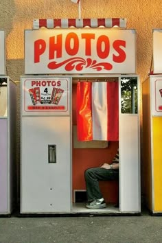 three vending machines sitting next to each other in front of a building