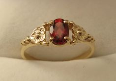 100% Australia Made BRAND  NEW  GENUINE  SOLID  9ct YELLOW GOLD   BEAUTIFULLY CRAFTED NATURAL GARNET DAISY DRESS RING Quality Ring HIGHLY POLISHED crafted with Precision & Detail  Suitable for every day wear and all ages. Will make a wonderful gift GENUINE SOLID GOLD   NOT FILLED   NOT HOLLOW   NOT PLATED   HALLMARKED (Stamped) 9ct Ring Weight : 1.6 grams to 1.8 grams approx. depending on size Ring Width : 6 mm widest point tapering to 1.5 mm Gemstone : Natural Garnet (6x4 oval 0.5ct approx.) Av Garnet Wedding Rings, Garnet Wedding, Vintage Gold Rings, Cute Engagement Rings, Daisy Dress, Dress Ring, Victorian Rings, Birthday Ring, Garnet Jewelry