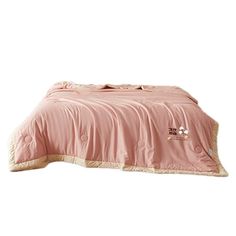 a bed with a pink comforter on top of it