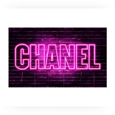 the word chanel is lit up in pink neon lights against a brick wall background