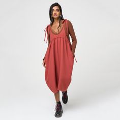 This adjustable pinafore is made from a sustainable tencel in a shade of summer berry. It features large, hidden pockets and an adjustable waist that can adapt to your desired fit.   100% Tencel | ethically crafted in our Romanian atelier  We recommend sizing down Machine wash at 30 degrees or hand wash Casual Red Suspender Dress For Spring, Casual Spring Pinafore Dress With Adjustable Straps, Casual Spring Pinafore Dress For Daywear, Summer Bib Front Dress With Pockets, Casual Dress With Adjustable Straps And Relaxed Fit, Casual Dresses With Bib Front And Pockets, Casual Bib Front Dress With Pockets, Red Pinafore, Pinafore Skirt