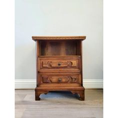 an old wooden cabinet with two drawers