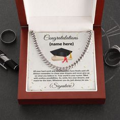 a graduation necklace in a red box with congratulationss on the front and back side