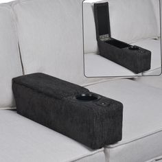 a couch with a cup holder on it's back and the seat upholstered