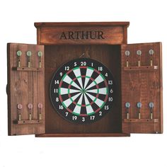 a wooden dart board with darts in it and the word arthrr written on it