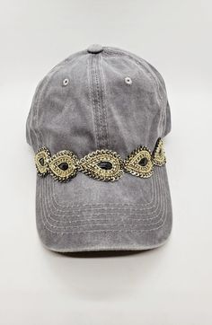 This is a new product from Handmade MKE! This is a distressed gray one size fits all baseball cap with a hole for your ponytail in the back, it is also adjustable. On the front of the hat is band of tear shaped embellishments made with rhinestones and sequins. This is very comfortable, and great to throw on with a plain white T-shirt! Like our Facebook Page and get 10% off when you message me before checkout! Everything made by handmade MKE is one of a kind and unique, however, if you would like Gray One Size Fits Most Snapback Hat, Gray One Size Fits Most Dad Hat, Adjustable Gray Trucker Hat With Curved Bill, Gray Adjustable Dad Hat Baseball Cap, Gray Adjustable Trucker Hat With Curved Bill, Adjustable Brimmed Gray Baseball Cap, Gray Visor Dad Hat, Adjustable Gray Visor Fitted Hat, Vintage Adjustable Brimmed Baseball Cap