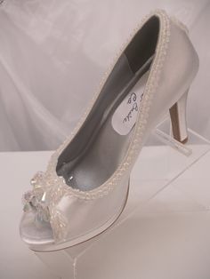 SALE THIS PAIR ONLY REG PRICE: $162.00 NOW: $138.00 READY TO SHIP SHOES USA SIZE: 5.5 (5 1/2), AS SHOWN IN PICTURE. *If you need a different color or size please see below. Beautiful Shoes for Todays Brides! : 3 1/4'' Heels Beautifully embellished with iridescent pearls edging; Shoes are peep toes with an iridescent embellishment, soooo, cute Shoes have platform to rest your feet :) the back heel of the shoe has a cute iridescent embellishment, please look at all the pictures *Need this shoe is Embellished Fitted Round Toe Wedding Shoes, Open Toe Embellished Wedding Shoes For Formal Occasions, White Open Toe Wedding Shoes For Gala, Fitted Silver Open Toe Wedding Shoes, Silver Open Toe Fitted Wedding Shoes, Embellished Fitted Wedding Shoes With Closed Toe, White High Heel Shoes, Modern Cinderella, Pretty Heels