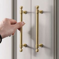 a person's hand is pushing the handle on a door