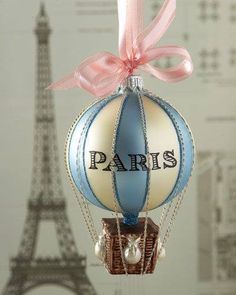 an ornament shaped like a hot air balloon with the eiffel tower in the background