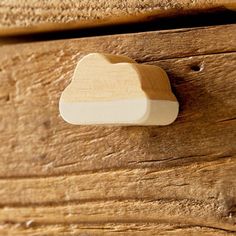 a close up of a wooden drawer with a white object on it's side