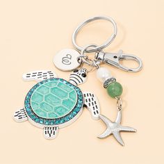 a keychain with a sea turtle and starfish on it