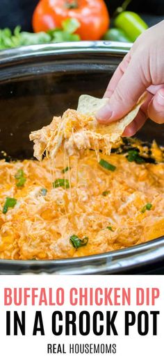 a hand is scooping some chicken dip into a crock pot