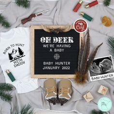 a baby announcement is displayed on a blanket with other items including shoes and t - shirts