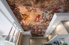 the ceiling in this kitchen is painted with an elaborate painting on it's wall