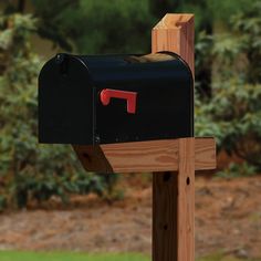 a black mailbox sitting on top of a wooden post