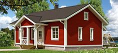 a small red house sitting on top of a lush green field