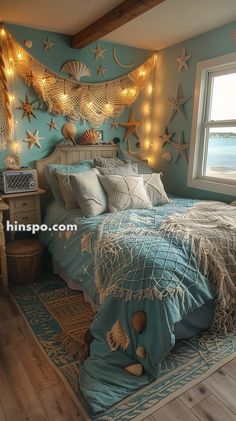 a bedroom decorated in blue and white with starfishs on the wall