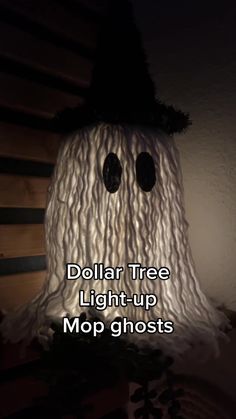 a fake ghost with the words dollar tree light - up mop ghosts