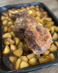 a roasting pan filled with potatoes and meat