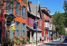 people are walking down the street in front of colorful buildings