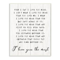 a white wooden sign with the words i love you the most on it and a handwritten