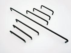 four black metal hooks on a white background