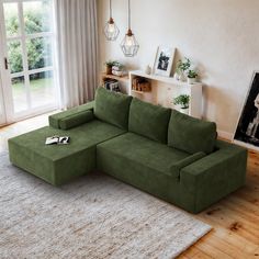 a green couch sitting on top of a wooden floor next to a white rug in a living room