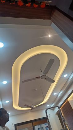 a man standing in front of a ceiling with a fan on it's side