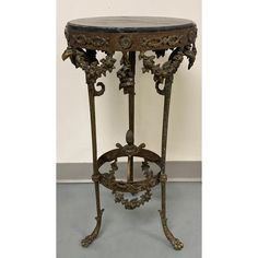 an ornate iron table with marble top