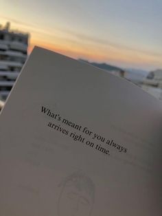 someone holding up a book with the words what's meant for you always arrives right on time