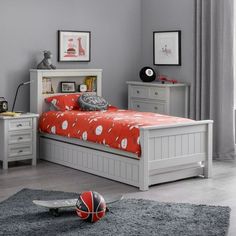 a bedroom with gray walls and white furniture, including a bed, nightstands, and a basketball on the floor