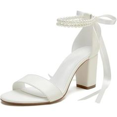 a white high heeled sandal with pearls on the ankle