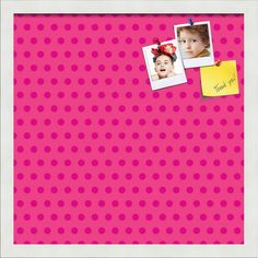 a pink polka dot wall with two pictures and a note