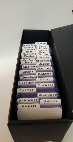 a box filled with lots of different types of business cards on top of a table