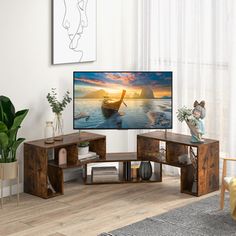 a flat screen tv sitting on top of a wooden stand in a living room next to a window