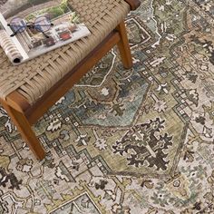 an area rug with a wooden bench and magazine on it