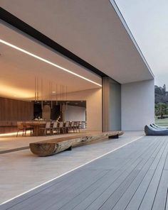 an outdoor living area with wooden flooring and large sliding glass doors that open up to the outdoors